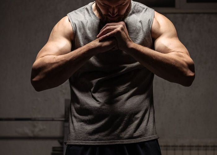 Close up of a man hands during a meditative strength pose
