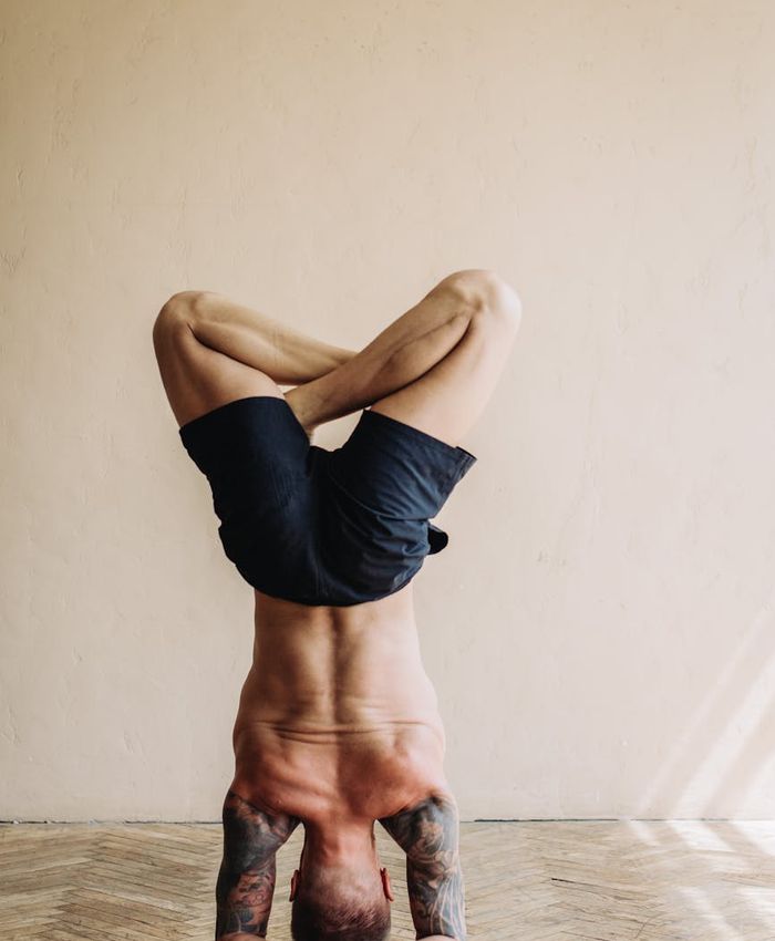 Strong man practicing focused stability exercises in a modern studio